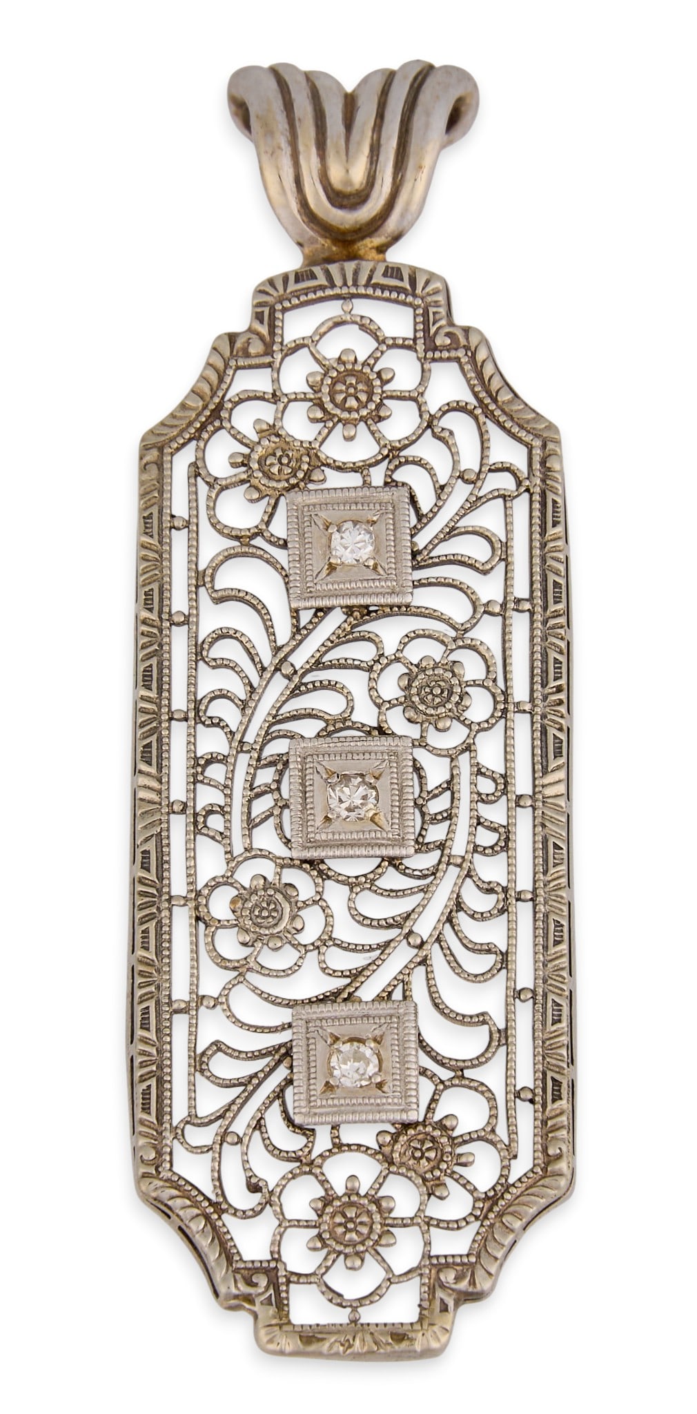 14K Diamond Filagree Pendant: 14K white gold filagree design pendant, set with three round cut diamond details, featuring floral motifs, marked "14K" Size: 2 in. x 0.5 in. Total weight: 3.1 g Provenance: Property