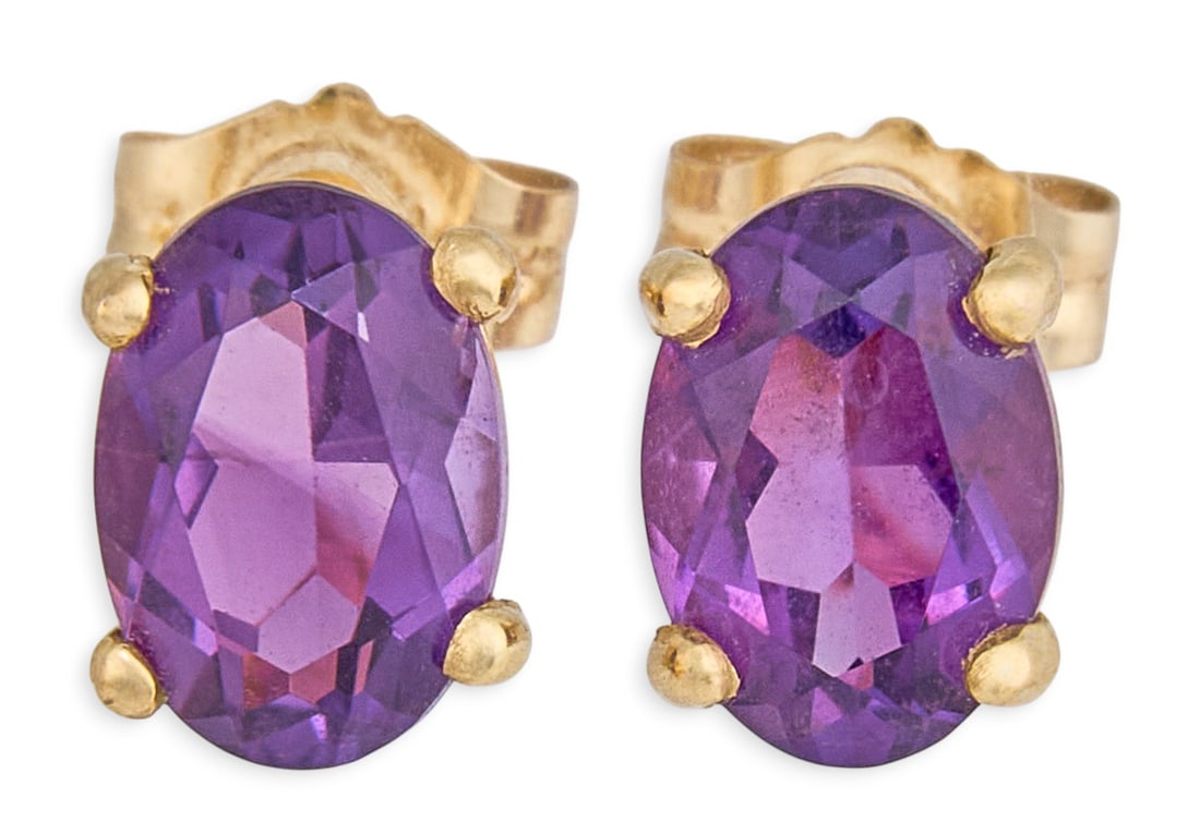 14K Amethyst Stud Earrings: Pair of 14K yellow gold stud earrings, set with oval cut amethysts, approximately 1.0 ctw, marked "14K Mexico" Total weight: 1.1 g Provenance: Property from a home in San Antonio, Texas