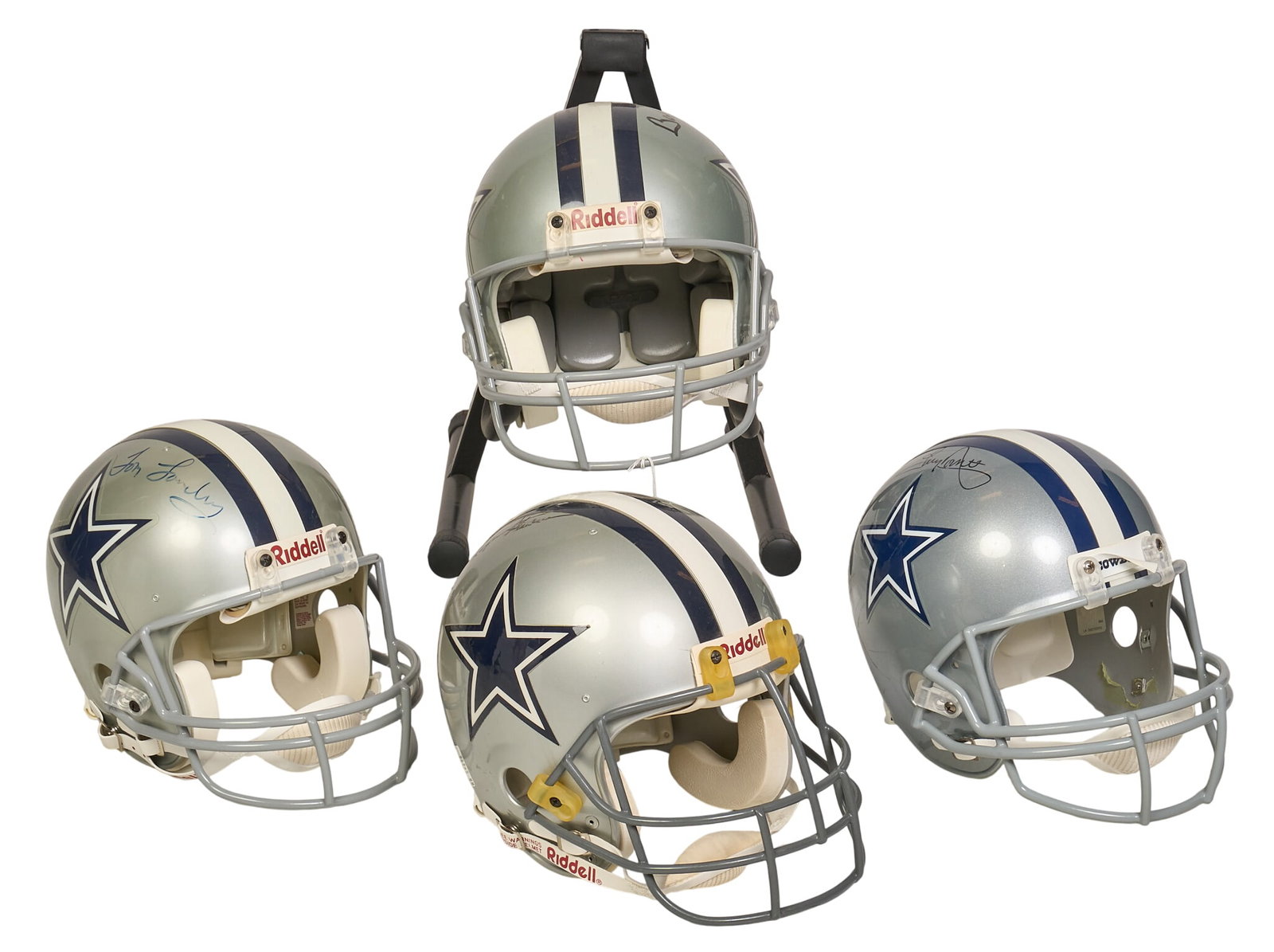 (4) Signed Dallas Cowboy Helmets: Collection of four signed Dallas Cowboy helmets, featuring signatures from Tony Dorsett, Tom Landy, Bob Lilly, and Roger Staubach height 15 in. x width 11 in. x depth 18 in. / largest