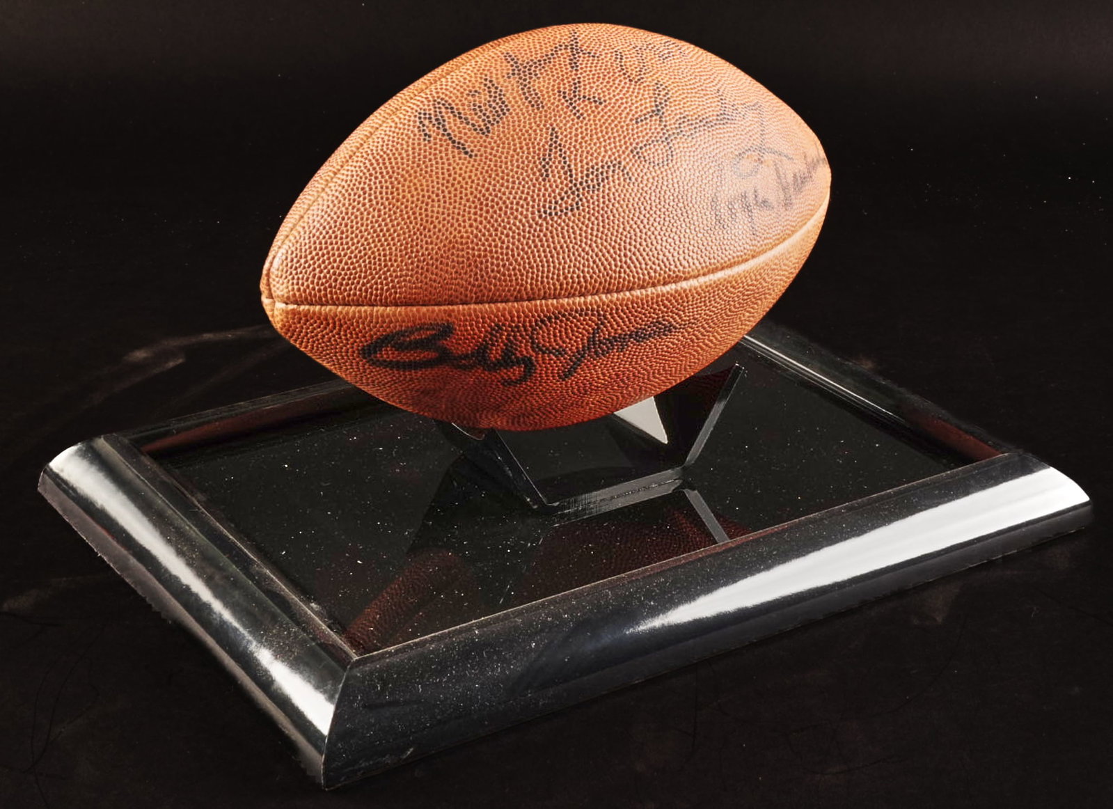 Multi-Signed Football: Football with multiple signatures from Tom Landry and Roger Staubach, and others, in display case height 9 in. x width 15 in. x depth 11 in. Provenance: Property from the Estate of Robert