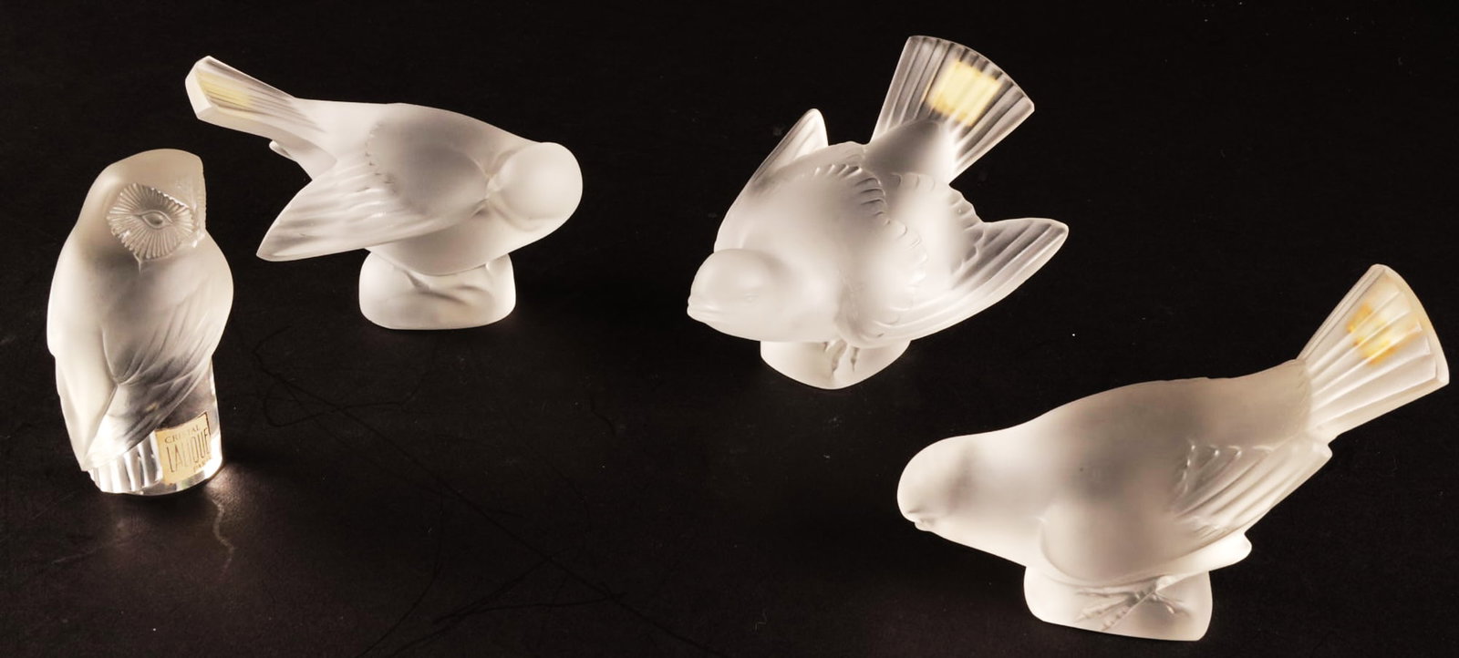 (4) Lalique Crystal Bird Figurines: Collection of four Lalique crystal bird figurines, includes three sparrow, and one owl height 3 in. x width 4 in. x depth 5.5 in. Property from a home in San Antonio, Texas 