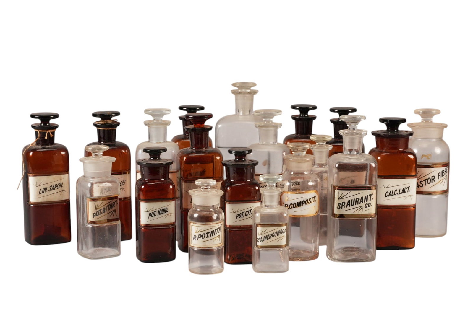 (19) Antique Apothecary Bottles: (19) Clear and amber antique apothecary bottles with labels height 9.5 in. x width 3.5 in. x depth 3.5 in. / largest Provenance: Property from a home in Boerne, TX