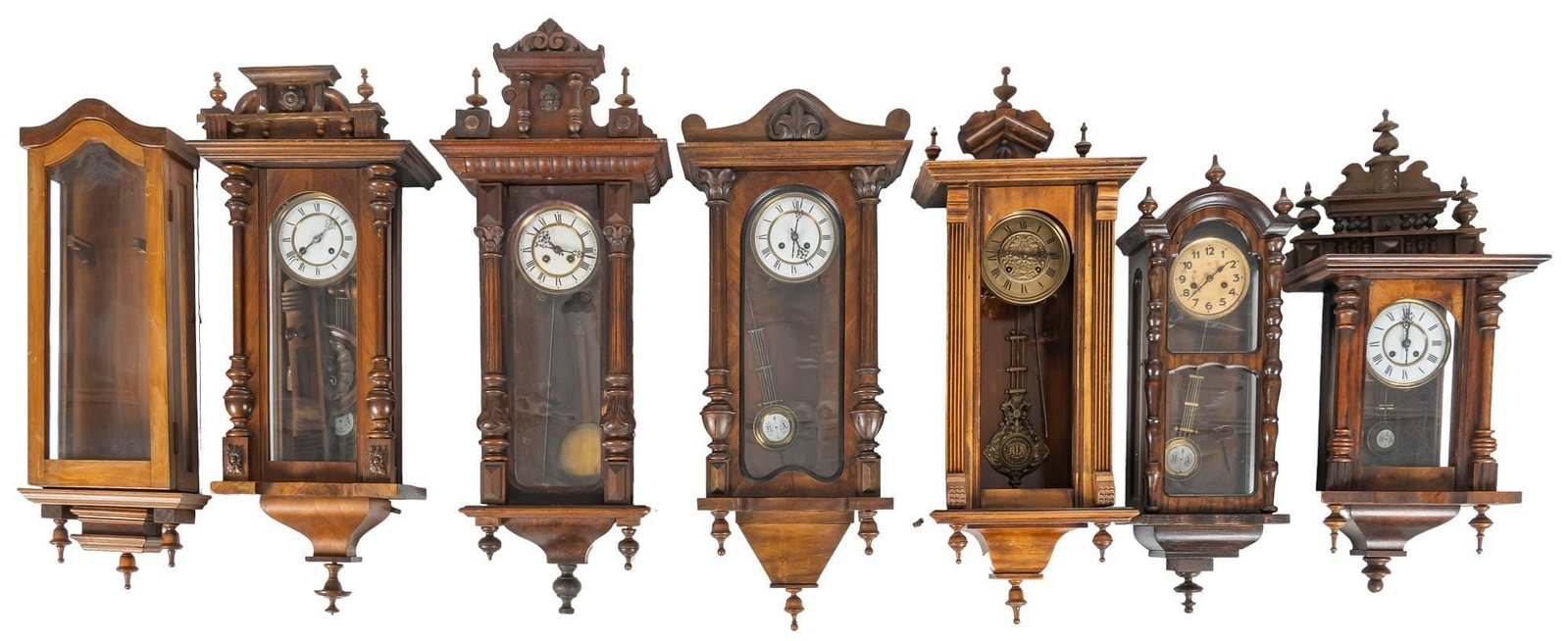 Collection of (6) Wall Clocks: Collection of six vintage wooden wall clocks, featuring a variety of styles, and types of wood height 43 in. x width 18 in. x depth 8 in. / largest Provenance: Property from a home in San