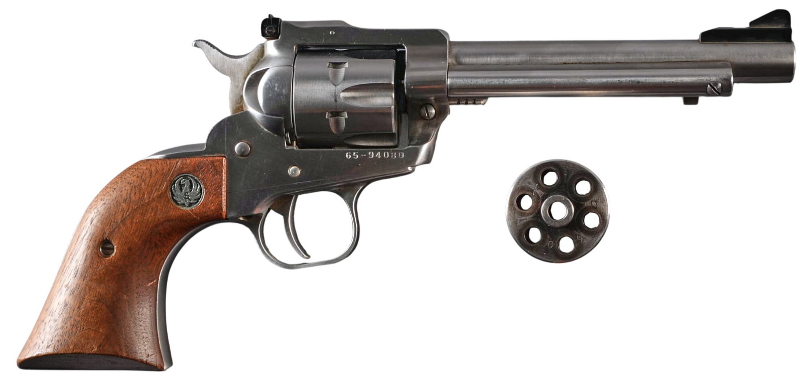 Ruger New Model Single-Six 22 LR / Magnum Revolver: Serial: 65-94080 Manufacturer: Ruger Model: New Single-Six Caliber: 22 LR / 22 Mag Barrel Length: 5.5 in. OAL: 11 in. Condition: Good; moderately used condition; some pitting in the cylinder
