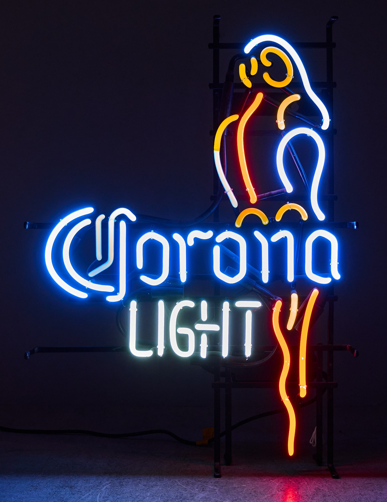 Corona Light Neon Sign: Corona Light beer neon sign with parrot, dated 2003, in working condition height 8 in. x width 20.5 in. x depth 6 in. Provenance: Property from the collection of Linda Muth, from her home in