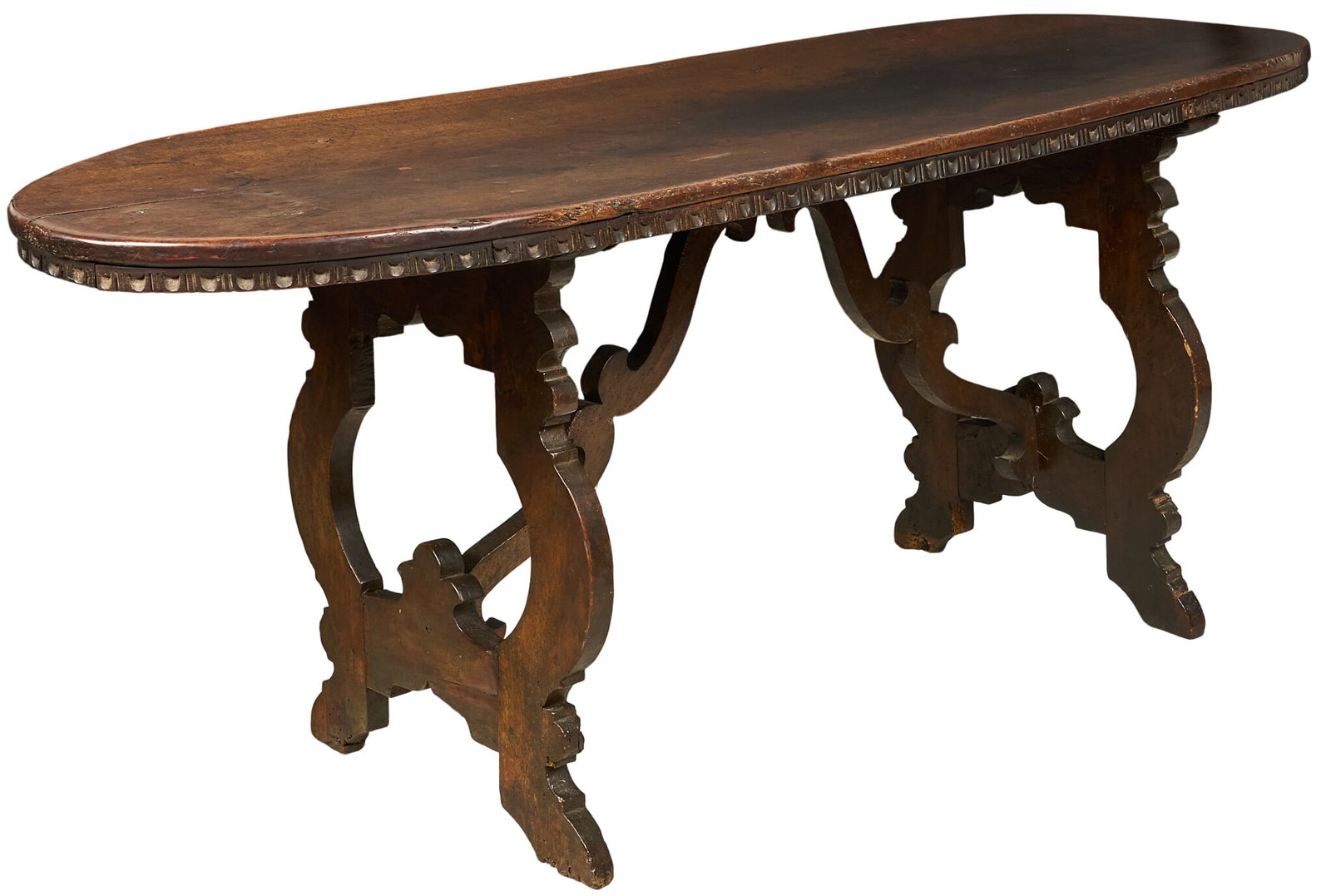 18th Century Walnut Table: 18th century walnut table with oval top on carved trestle legs height 32 in. x width 79 in. x depth 26.5 in. Provenance: Property from a home in San Antonio, Texas 