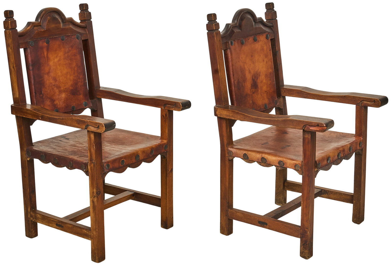 Pair of Hacienda Style Chairs: Pair of hacienda style chairs, with leather upholstery to seat and back, on carved wooden frame height 42 in. x width 24 in. x depth 25 in. / each Provenance: Property from a home in