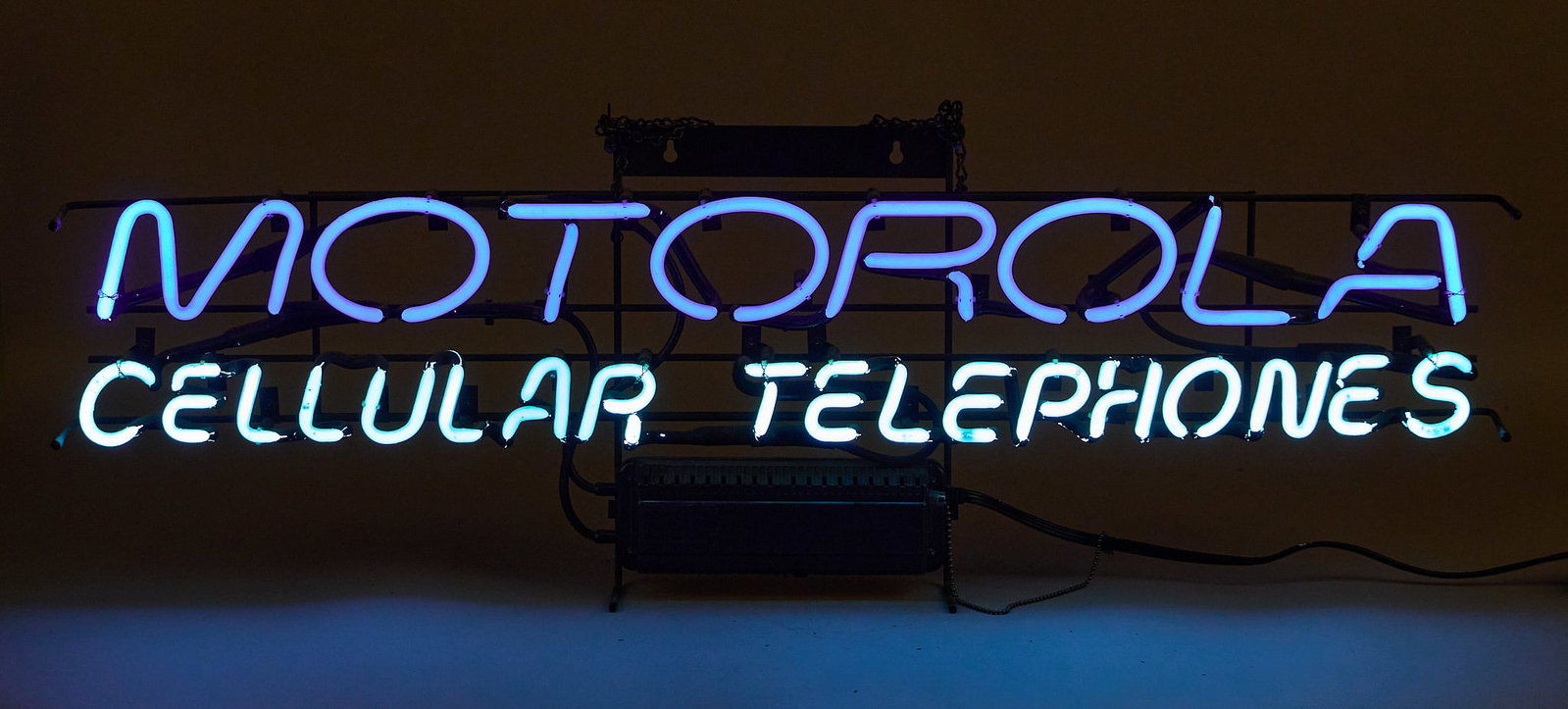 Motorola Cellular Telephones Neon Sign: Motorola Cellular Telephones neon sign, circa 21st century, in working condition height 13.5 in. x width 38 in. x depth 4 in. Provenance: Property from a home in San Antonio, Texas 