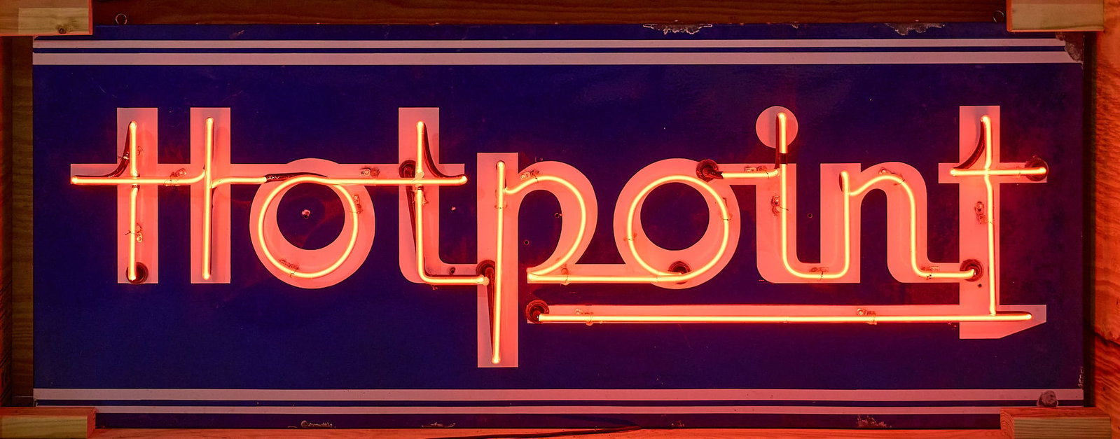 Hotpoint Neon Sign: Original porcelain neon sign for Hotpoint Appliances height 28 in. x width 70 in. x depth 8 in. Provenance: Property from a home in San Antonio, Texas