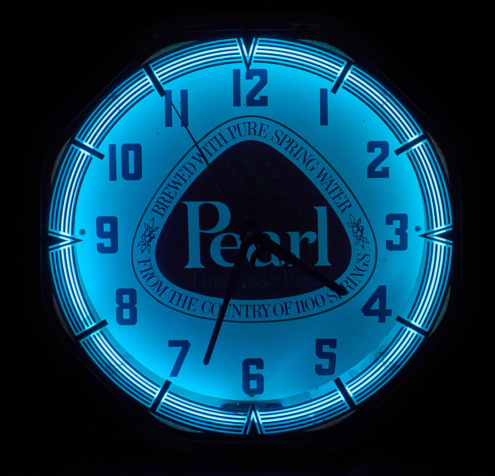 Pearl Beer Neon Clock: Pearl Beer neon advertising clock, mid-20th century, circular illuminated dial featuring the Pearl Beer logo and "Brewed with pure spring water from the Country of 1100 Springs" slogan, blue