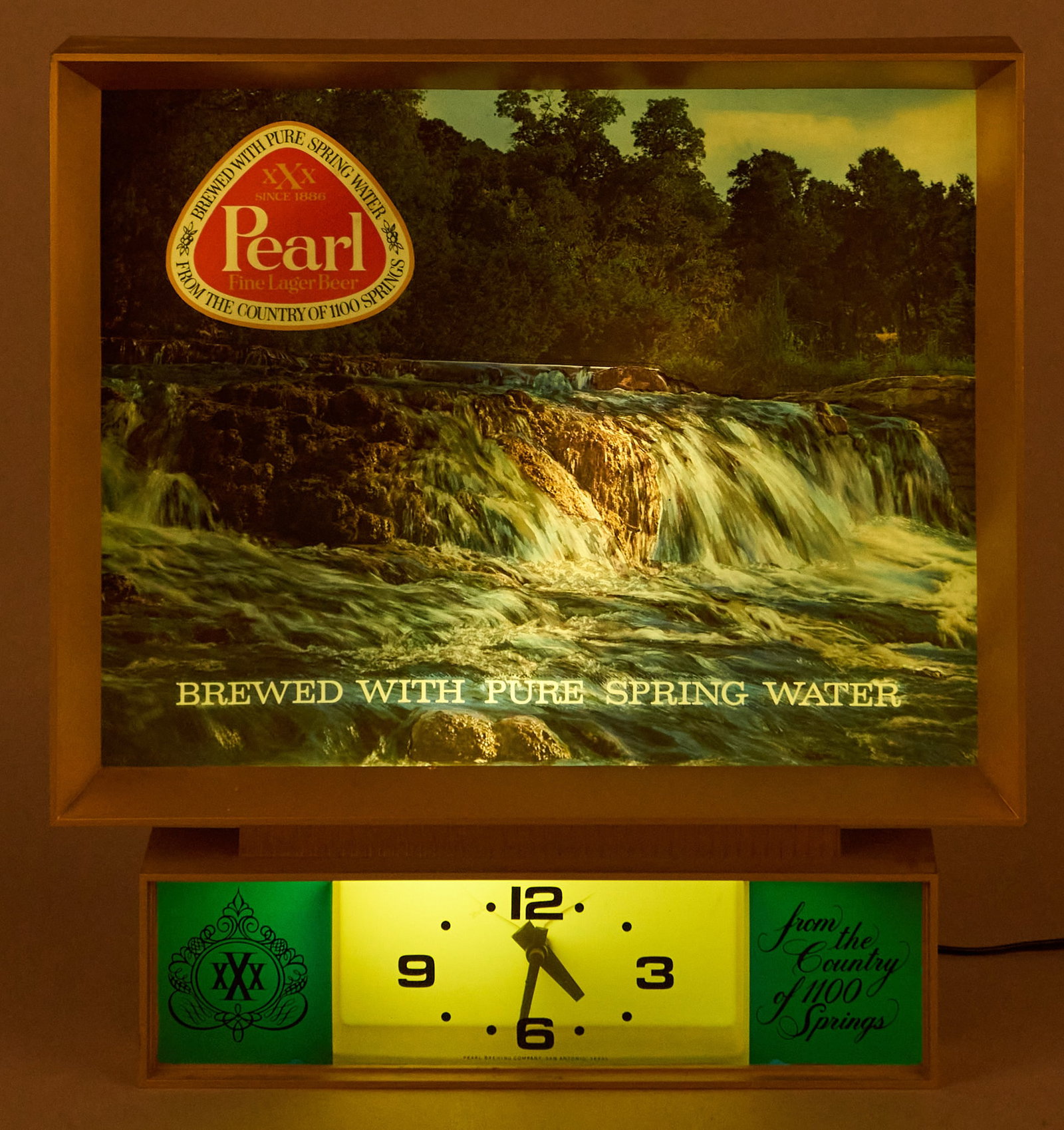 Pearl Beer Lighted Clock: Pearl Beer lighted clock with moving waterfall backdrop, in working condition height 17 in. x width 16 in. x depth 5.5 in. Provenance: Property from the collection of Linda Muth, from her h