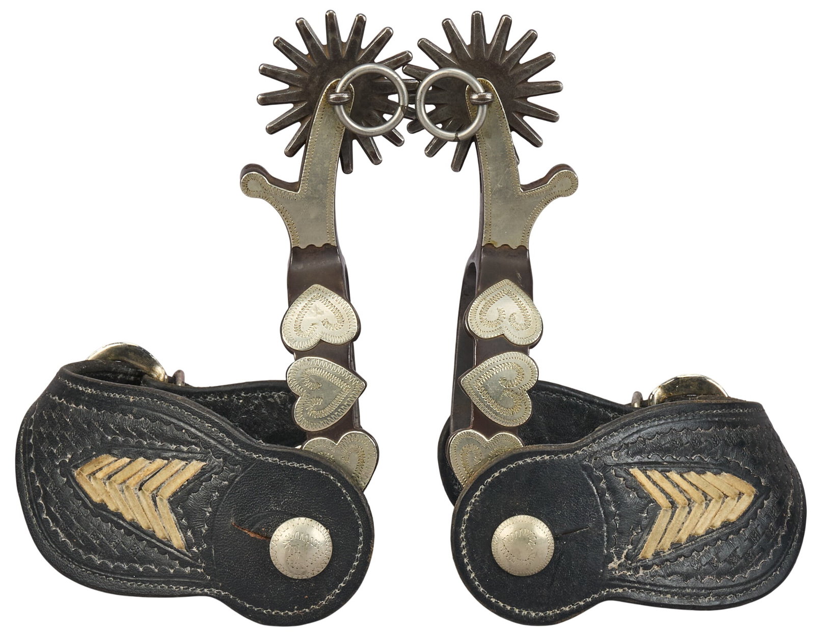 Pair of Fredieu 1984 3 Heart Pattern Spurs: Pair of maker marked "Fredieu 1984" 3 heart pattern spurs with tooled leather and decorative stitching overall length: 7 in. heel width: 3 in. rowel diameter: 2 in. Provenance: Propert