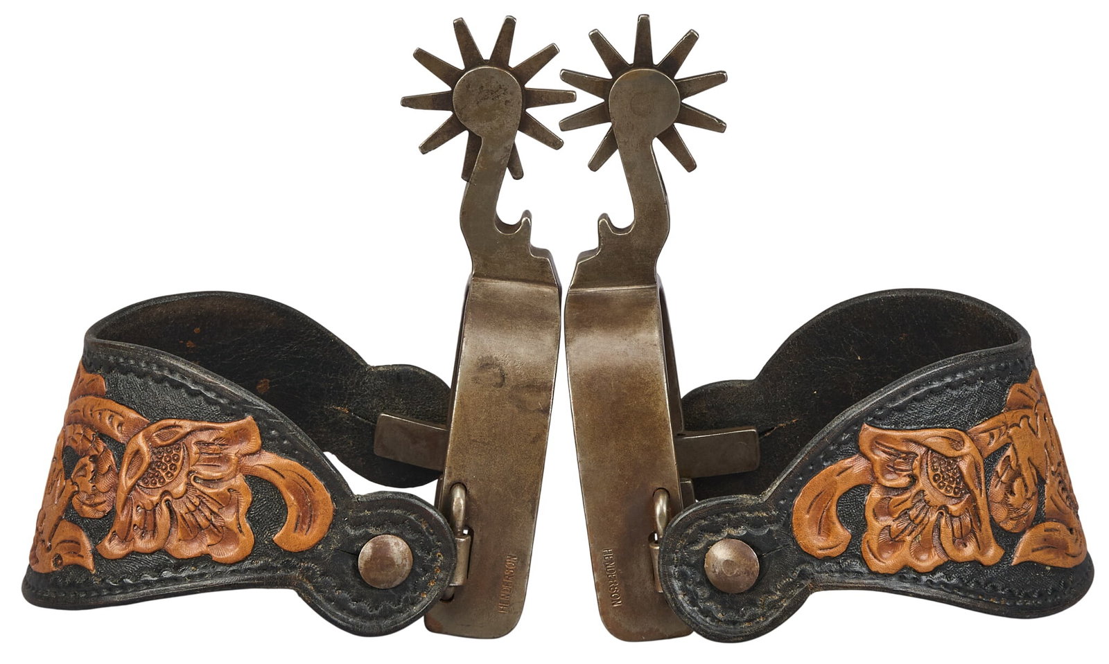 Pair of "Henderson" Maker Made Spurs: Pair of marked "Henderson" maker made bottle opener shank spurs, with tooled and monogrammed dual toned leather heel strap and silver overlay overall length: 7 in. heel width: 3.5 in. rowel 