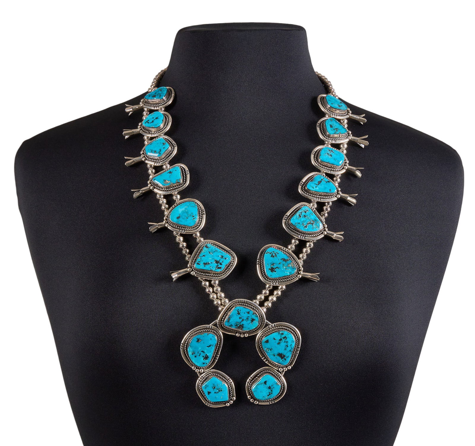 Vintage Sterling & Turquoise Squash Blossom: Vintage sterling silver squash blossom necklace, set with turquoise sones and twisted rope motifs, signed "F. Sandoval" Length: 27 in. Total weight: 195.6 g Provenance: Property
