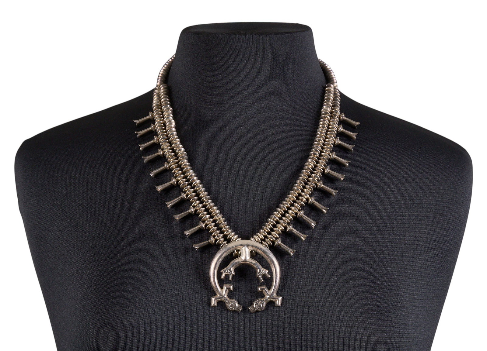 Sterling Silver Rainbow Man Squash Blossom: Sterling silver squash blossom necklace, with rainbow man motif to naja, marked "Sterling" Length: 23 in. Total weight: 121.0 g Provenance: Property from a home in San Antonio, Texas