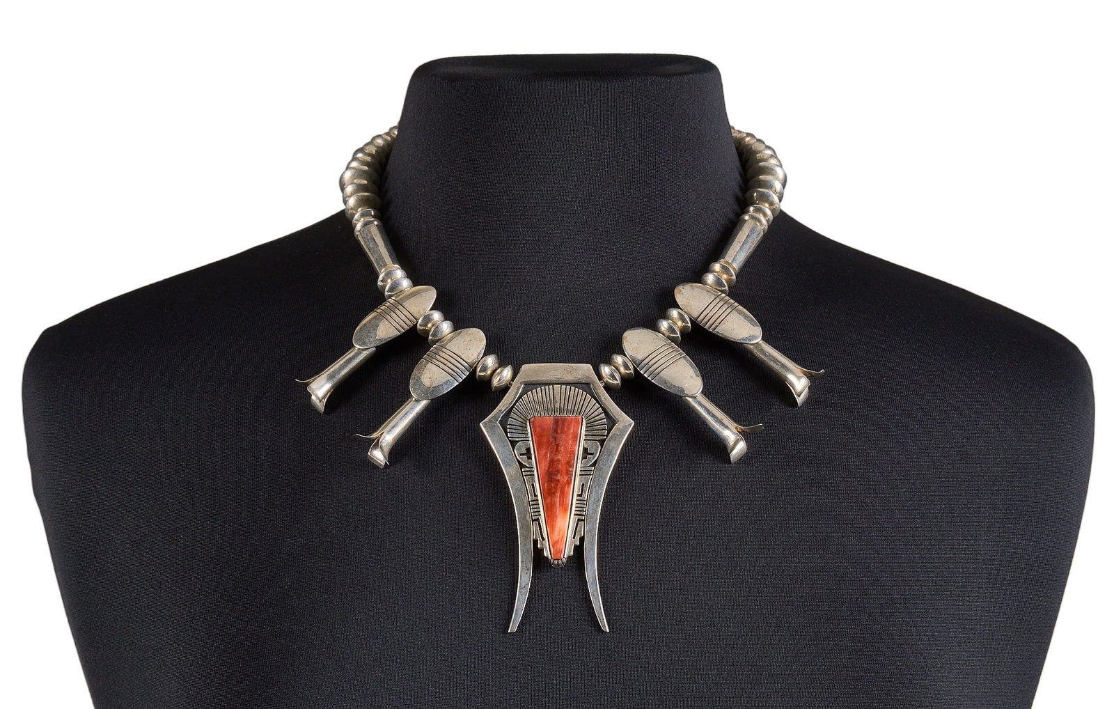Nelson Begay, Modernist Sterling & Spiny Oyster Squash Blossom: Nelson Begay, modernist style Navajo sterling silver squash blossom necklace, pendant set with large spiny oyster stone, with stamped details throughout, hook and eye closure, marked "Sterling NJ