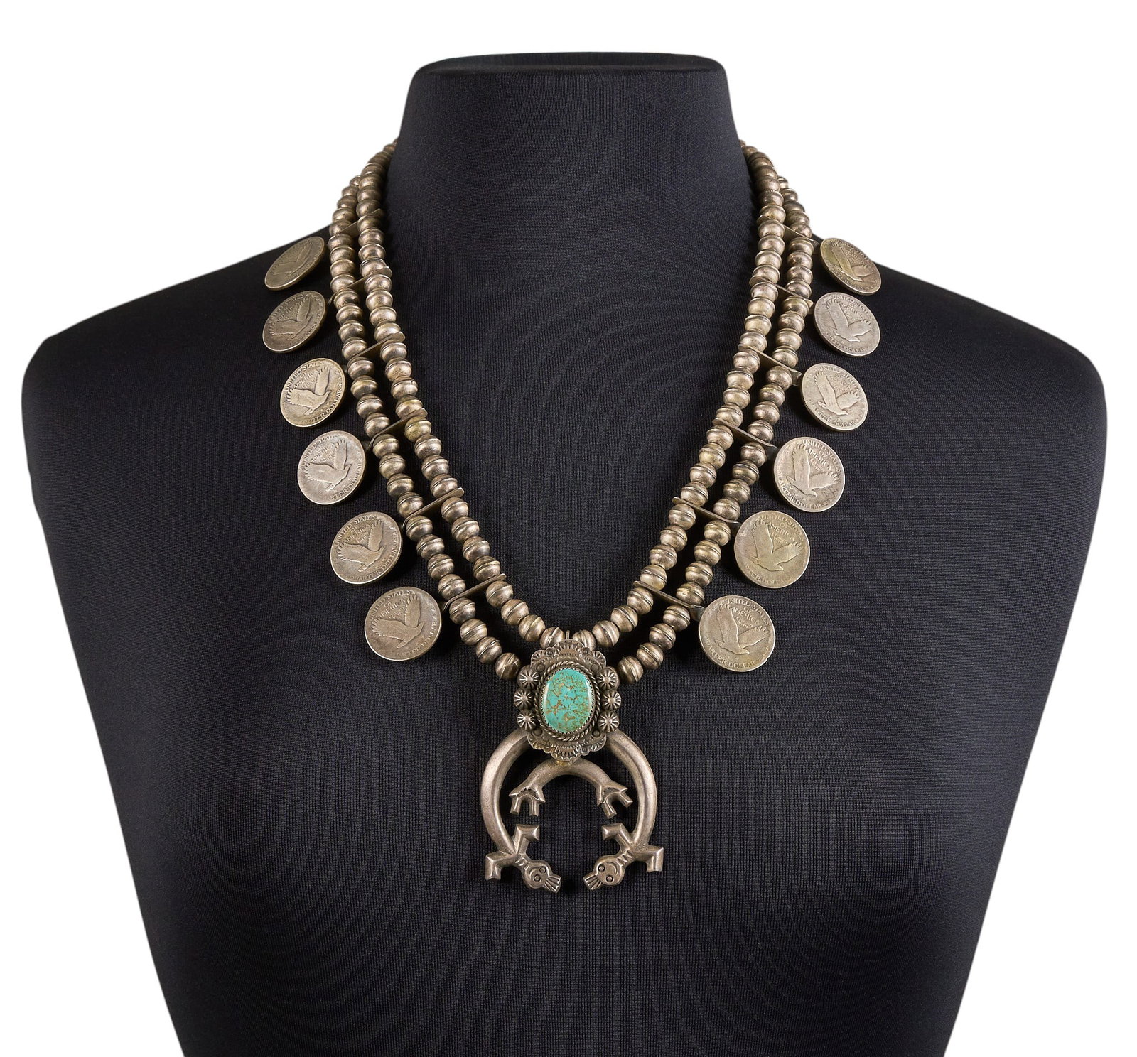 Coin Silver & Turquoise Quarter Necklace: Jim Urban "Chief Red Feather" Brady, Navajo coin silver necklace, set with turquoise cabochon and figural motif to pendant, featuring twelve quarters on two strands of silver beads, signed &