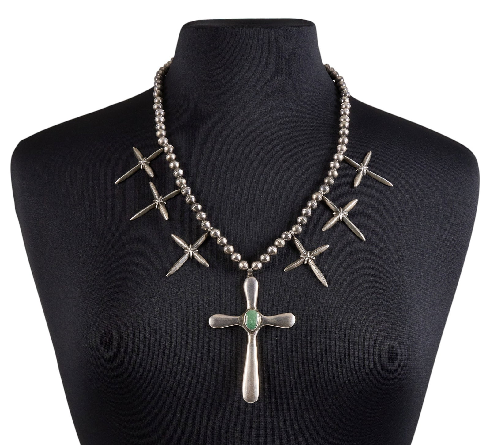 Navajo Sterling & Turquoise Cross Pendant Necklace: Navajo sterling silver cross pendant necklace, pendant set with single turquoise cabochon, with hook and eye closure Length: 25 in. Total weight: 93.6 g Provenance: Property from an Austin, 