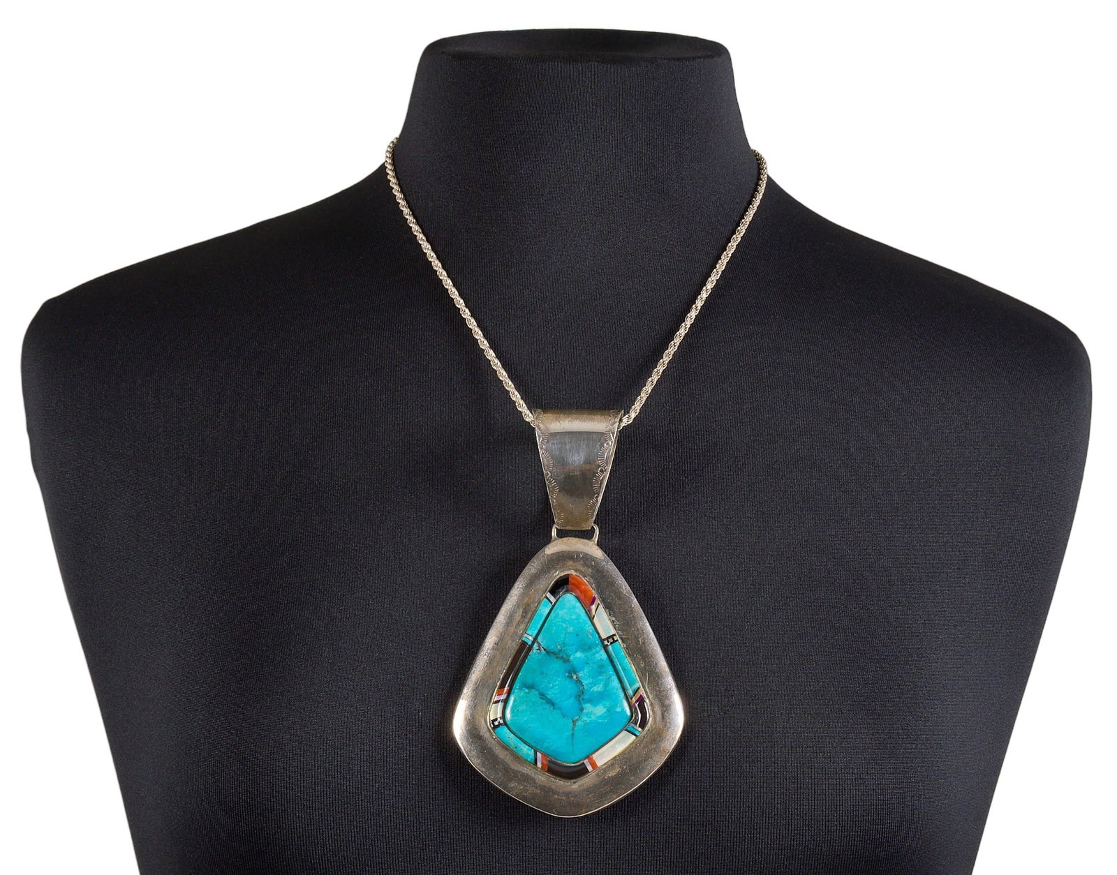 Sterling & Multi-Stone Pendant Necklace: Sterling silver pendant necklace, set with large turquoise center stone and multi-stone inlay, featuring stamped details, marked "Sterling" Size: 5 in. x 2.75 in. / pendant Length: 20 in. / 