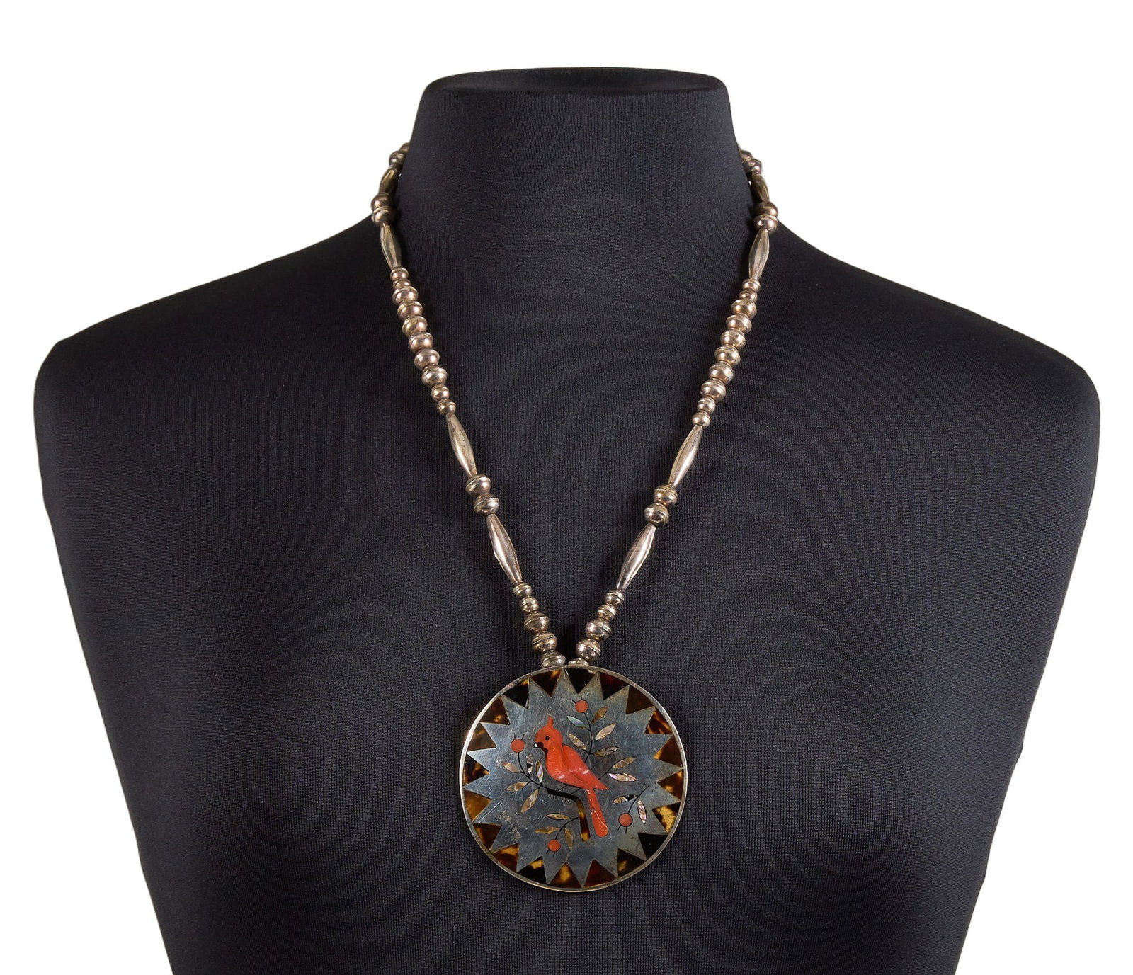 Zuni Sterling & Multi-Stone Cardinal Pendant Necklace: Sammy and Esther Guardian, vintage Zuni sterling silver pendant necklace, pendant set with multi-stone inlay with cardinal motif, signed to pendant's reverse, dated 1975 Length: 25 in. Total 