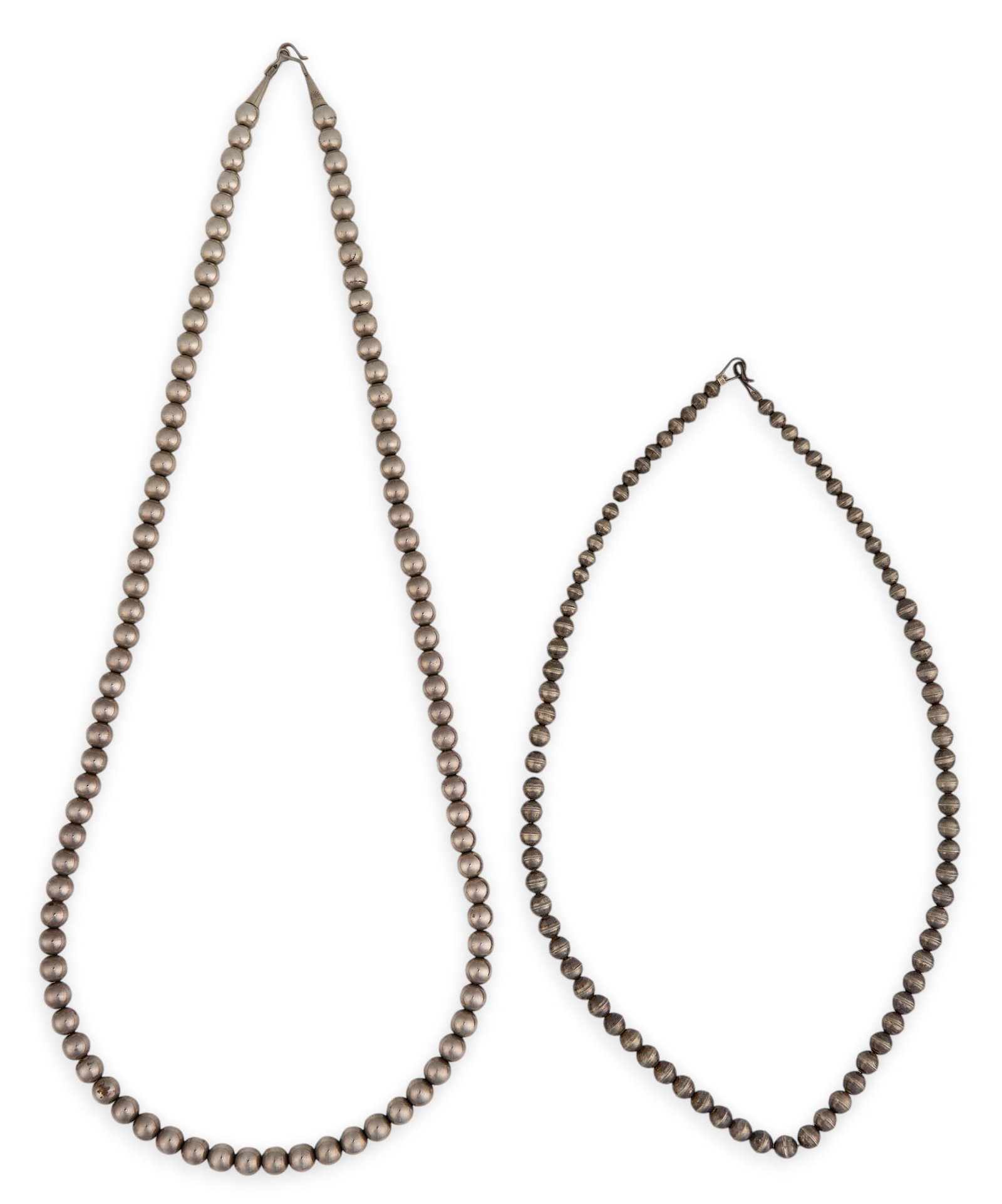 (2) Navajo Sterling Silver Pearl Strands: Two Navajo sterling silver pearl strands, each with hook and eye closure Length: 30.5 in. / longest Total weight: 63.5 g Provenance: Property from an estate in Austin, Texas