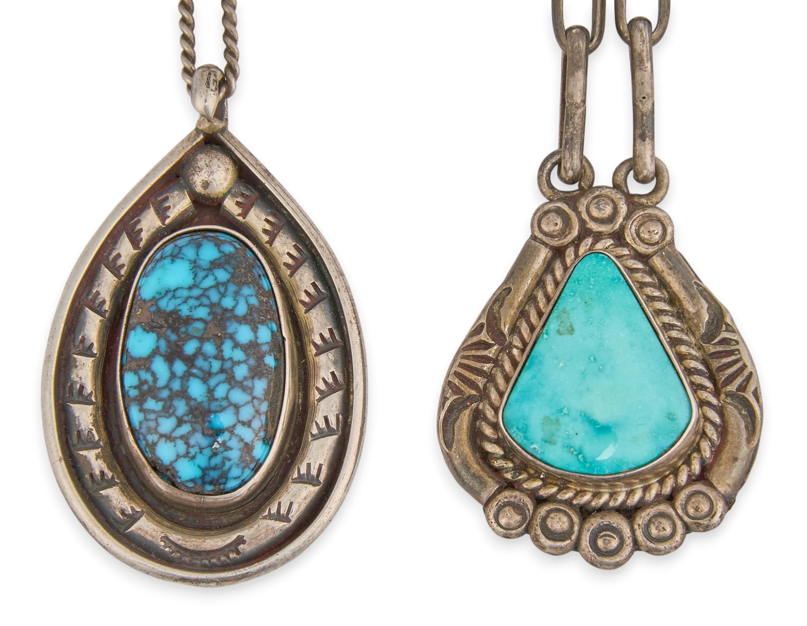 (2) Navajo Sterling & Turquoise Pendant Necklaces: Two Navajo sterling silver pendant necklaces, one set with with Kingman turquoise, the other possibly set with Lander blue turquoise, both on Navajo chains Length: 18 in. / each Total weight: 36.