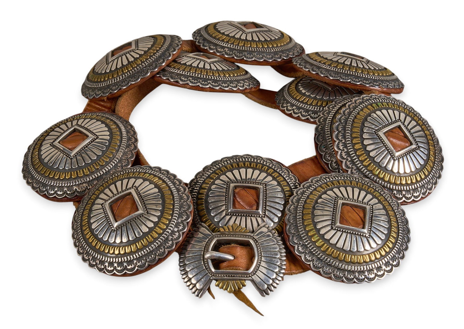 Walt Duran, Vintage SW Shop Sterling Concho Belt: Walt Duran, vintage Southwestern shop sterling silver concho belt, with eleven conchos and buckles with gold-toned details and etched design, on brown leather belt, buckle marked Length: 43 in. T