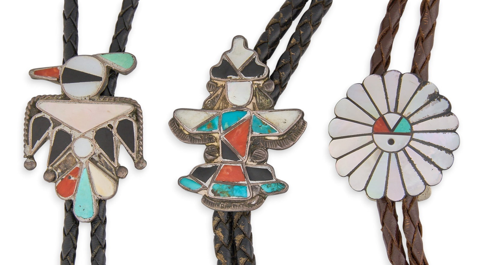 (3) Zuni Multi-Stone Inlay Bolos: Three Zuni bolo ties, set with multi-stone inlay, depicting figural motifs, on braided leather cords, marked Length: 41 in. / longest Total weight: 79.2 g Provenance: Property from an estate in Austin