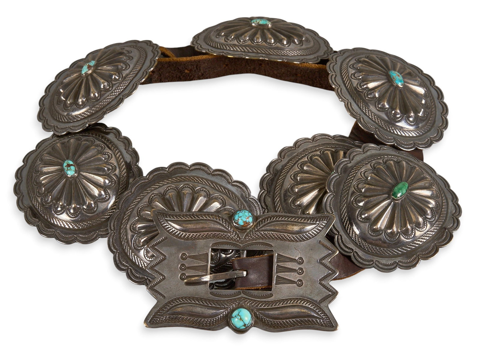 Turquoise Concho Belt: Concho belt with seven conchos and buckle on brown leather belt, set with turquoise cabochons Length: 37 in. Total weight: 547.3 g Provenance: Property from a home in San Antonio, Texas