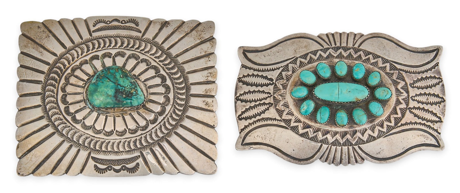 (2) Navajo Sterling & Turquoise Buckles: Two Navajo sterling silver buckles, set with turquoise stones and stamped details, marked "Sterling JS" and "M Sterling" Size: 3 in. x 2.5 in. / largest Total weight: 141.8 g Prove