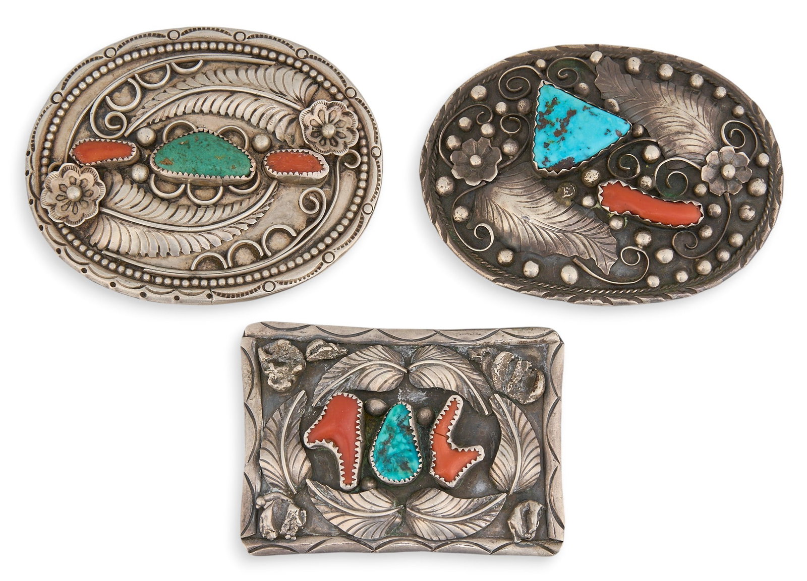 (3) Sterling Silver Turquoise & Coral Buckles: Three sterling silver buckles, set with turquoise and coral, featuring feather and twisted rope motifs, all signed Size: 3.5 in. x 2.5 in. / largest Total weight: 193.0 g Provenance: Property from a