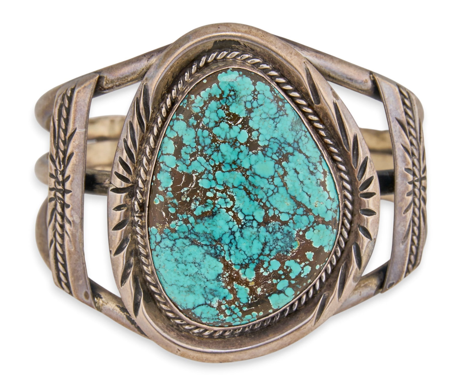 Sterling & Turquoise Cuff: Sterling silver cuff bracelet, set with large turquoise stone, featuring stamped details and twisted wire motifs, marked "Sterling" Circumference: 6.5 in. Total weight: 72.3 g Provenance: Pr