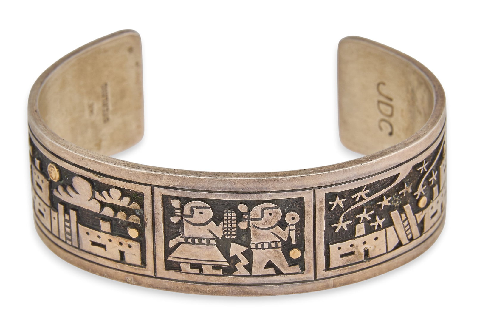 Joseph Coriz, Santo Domingo Sterling Cuff: Joseph Coriz, Santo Domingo sterling silver cuff bracelet with storyteller motifs, and 14K overlay , marked "JDC 14K Sterling" Circumference: 6.75 in. Total weight: 56.4 g Provenance: