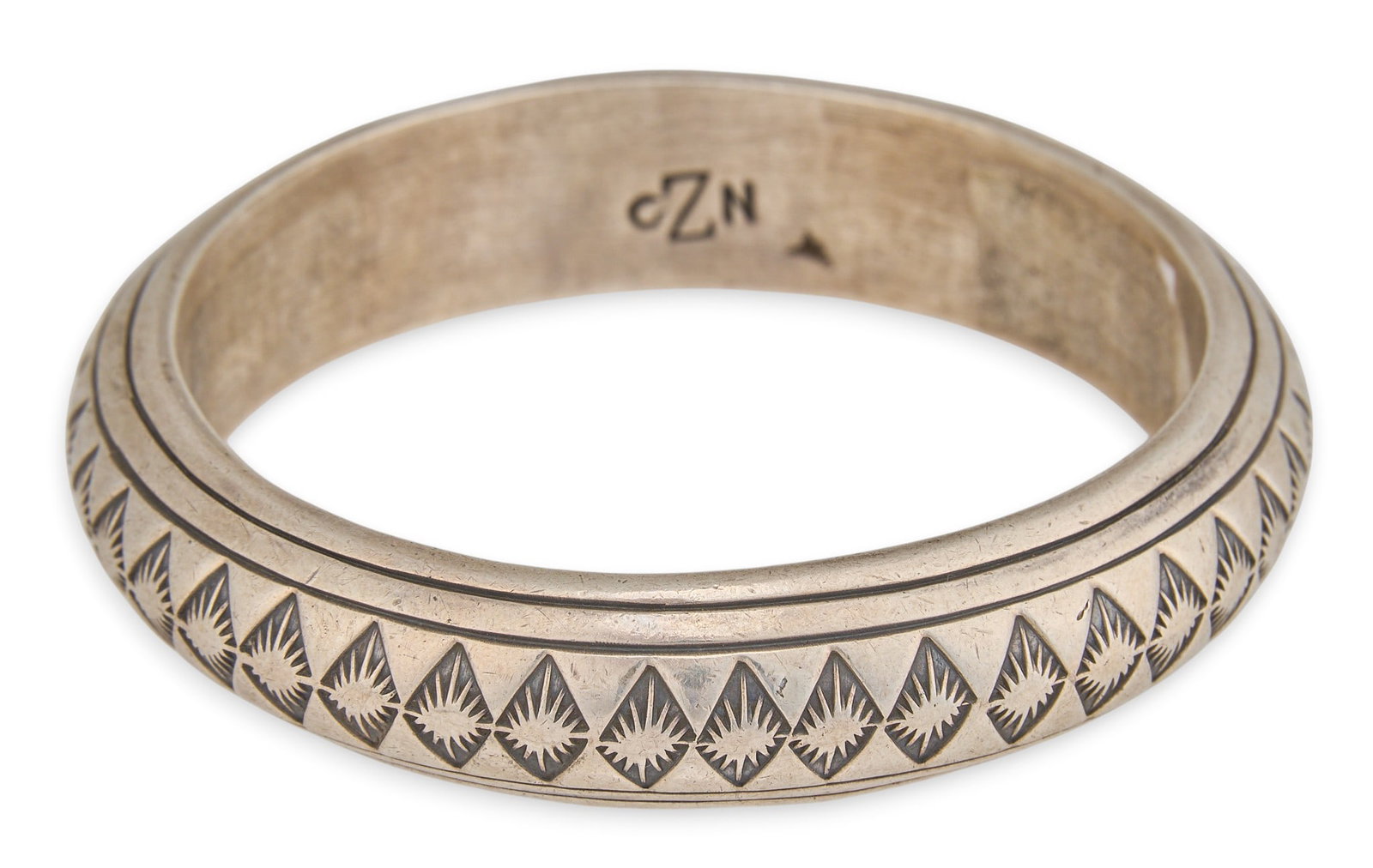 Gibson Nez, Navajo Sterling Silver Bangle: Gibson Nez, Navajo sterling silver cuff bracelet, with stamped motifs in geometric design, signed "GZN" Circumference: 8 in. Total weight: 79.0 g Provenance: Property from an Austin, Texas e