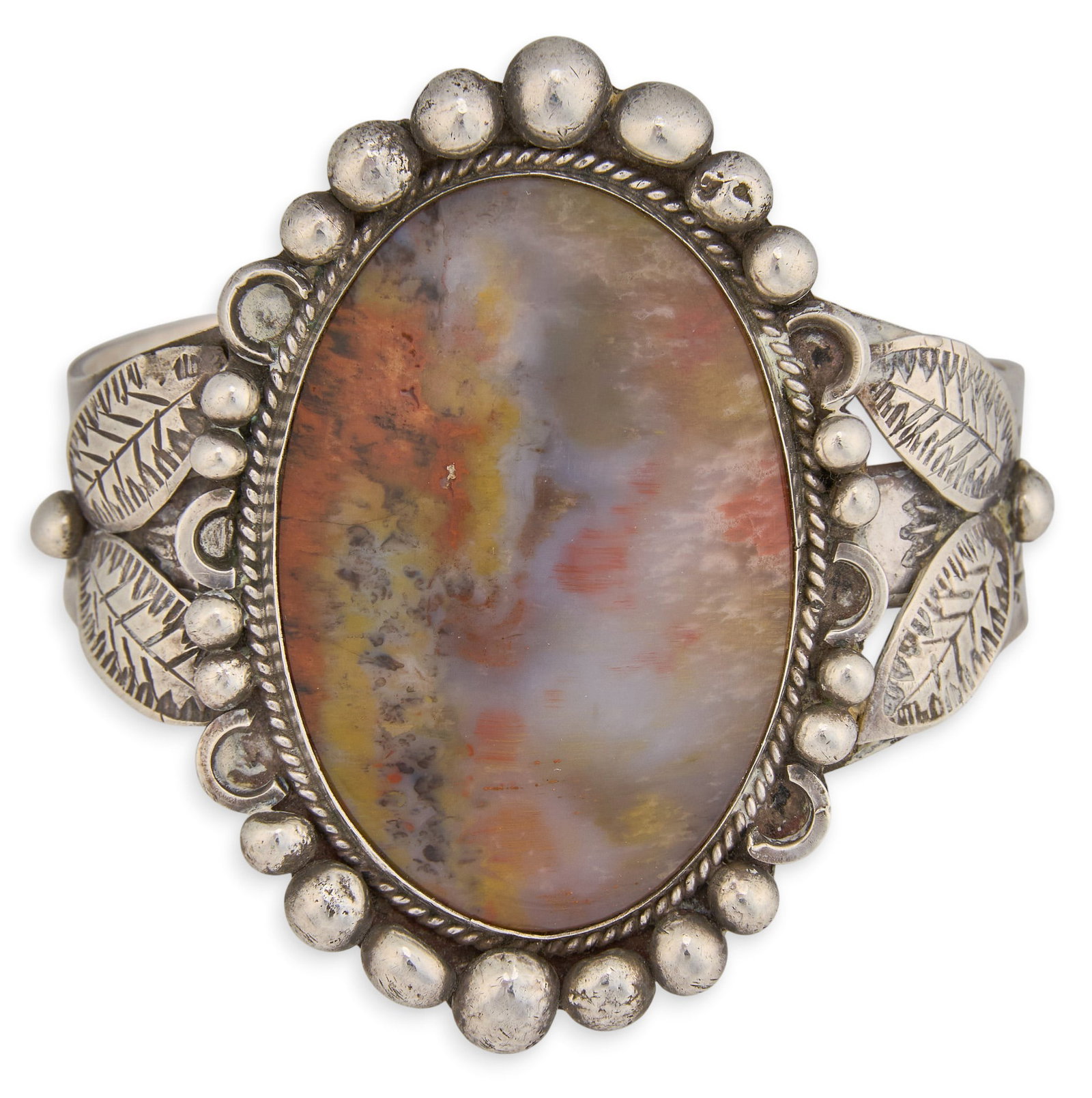 Sterling Silver & Hardstone Cuff: Sterling silver cuff bracelet, set wit single large hardstone, featuring leaf motifs and stamped details throughout Circumference: 6.25 in. Total weight: 65.2 g Provenance: Property from a home in