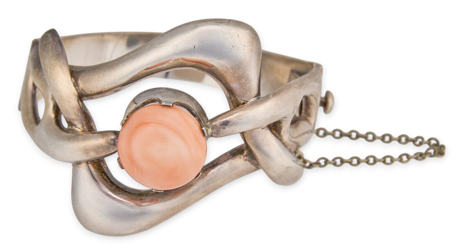 Mexican Sterling & Angel Skin Coral Cuff: Mexican sterling silver cuff bracelet, set with angel skin coral cabochon, with safety chain, marked "Cheo Mexico Taxco 925" Circumference: 7 in. Total weight: 66.8 g Provenance: Property