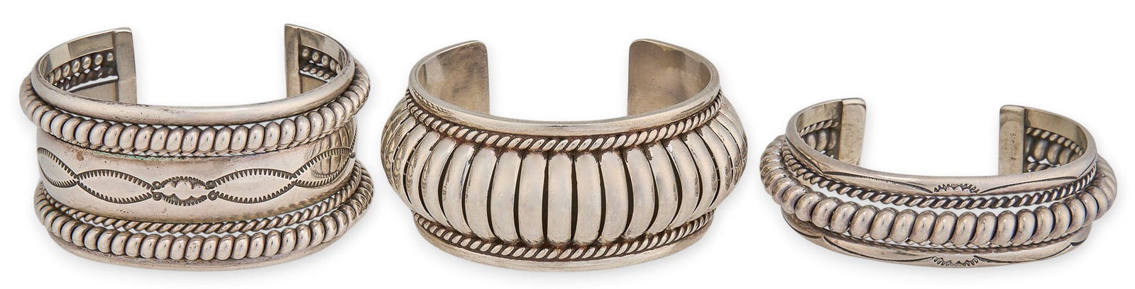 (3) Navajo Sterling Silver Twisted Wire Cuffs: Three Navajo sterling silver cuffs, each featuring twisted wire motifs and hand-stamped details, two signed "Tahe", and one signed "A. Douglas" Circumference: 6.5 in. / each