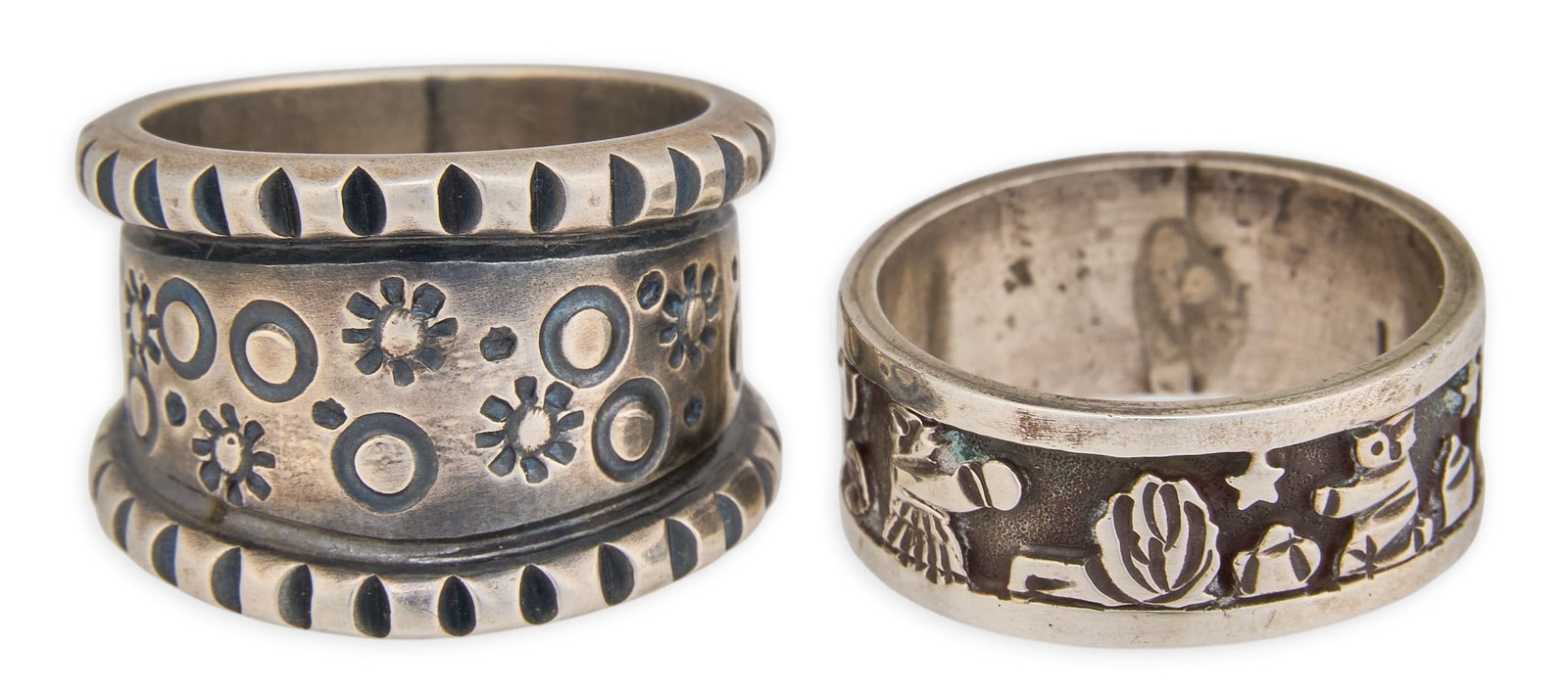 (2) Navajo Sterling Silver Men's Rings: Two Navajo sterling silver men's rings, featuring various stamped motifs, signed Monty Claw and Lloyd Becenti Size: 11, 11.5 Total weight: 25.9 g Provenance: Property from an Austin, Texas es