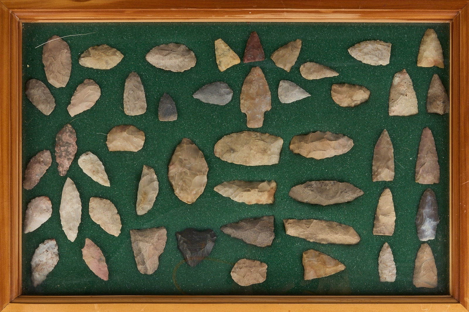 Framed Arrowhead Display: Framed display of arrowheads and projectile points, with green felt lining height 2 in. x width 18 in. x depth 12 in. Provenance: Property from a home in San Antonio, Texas