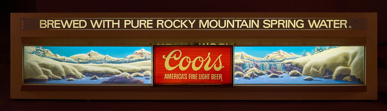 1976 Coors Winter Light and Clock: 1976 Coors Winter lighted clock sign with winter background, in working condition height 12.5 in. x width 51 in. x depth 6 in. Provenance: Property from the collection of Linda Muth, from