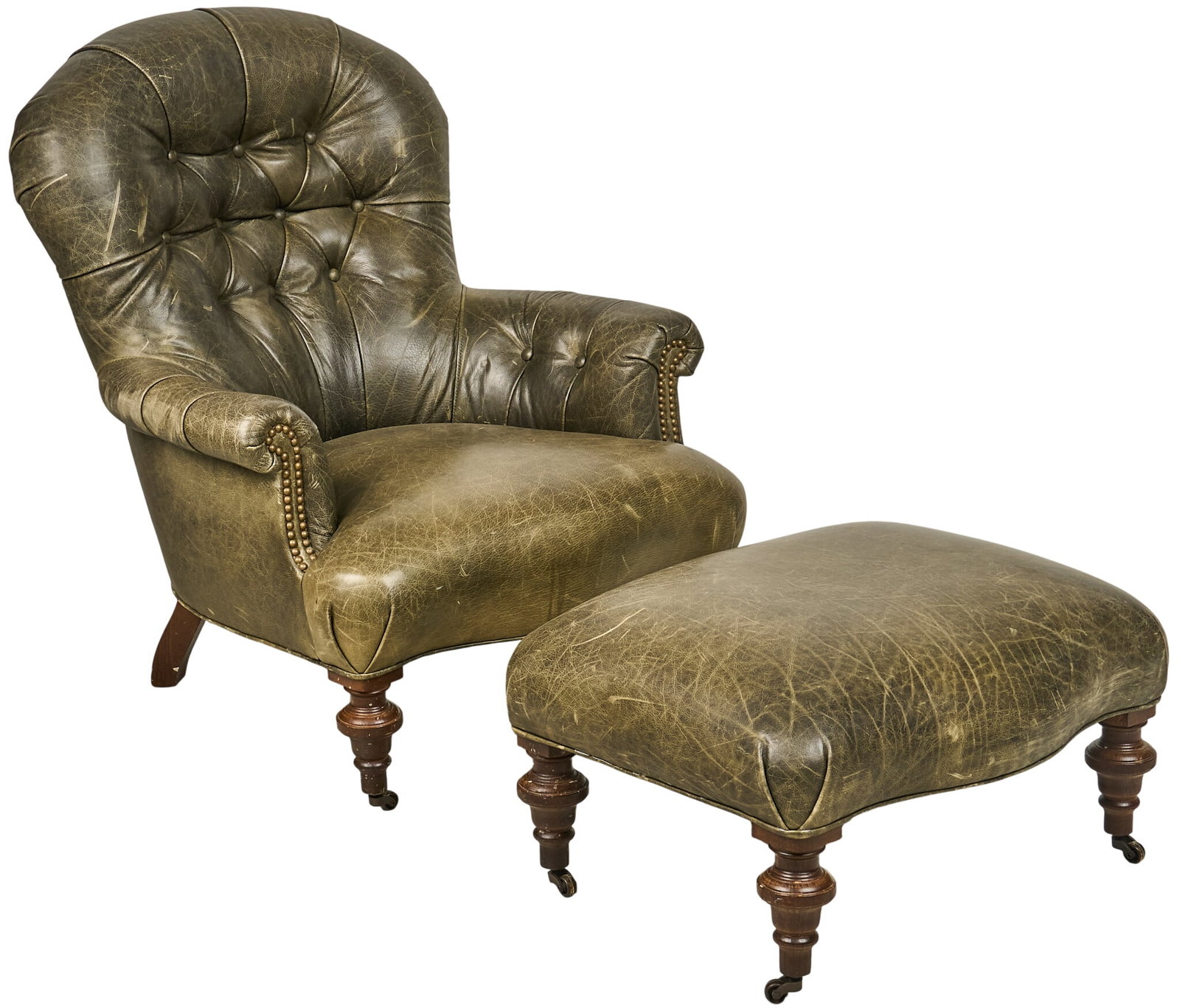 Leather Chair and Ottoman: Tufted leather armchair with matching ottoman, supported on turned legs with wheels height 39 in. x width 32 in. x depth 36 in. Provenance: Property from a home in San Antonio,