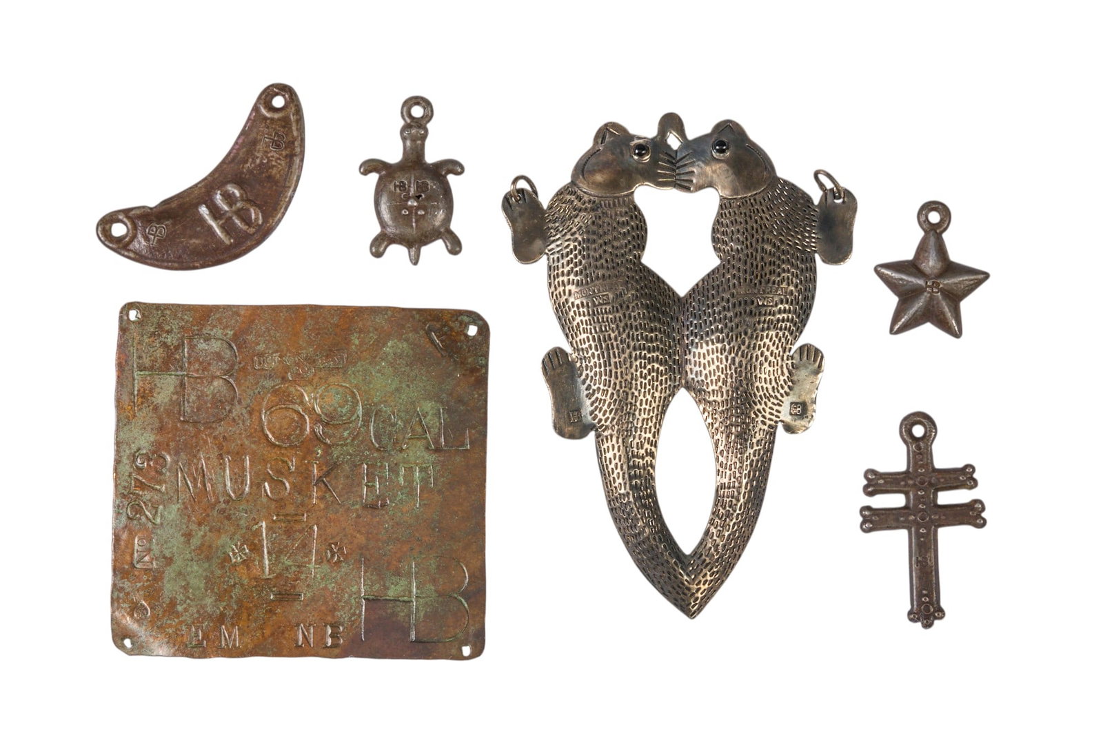 Collection of (6) Hudson Bay Trade Items: Framed collection of six Hudson Bay trade items, five metal pendants and one plaque height 3 in. x width 12 in. x depth 8.5 in. / case Provenance: Property from a home in Austin,