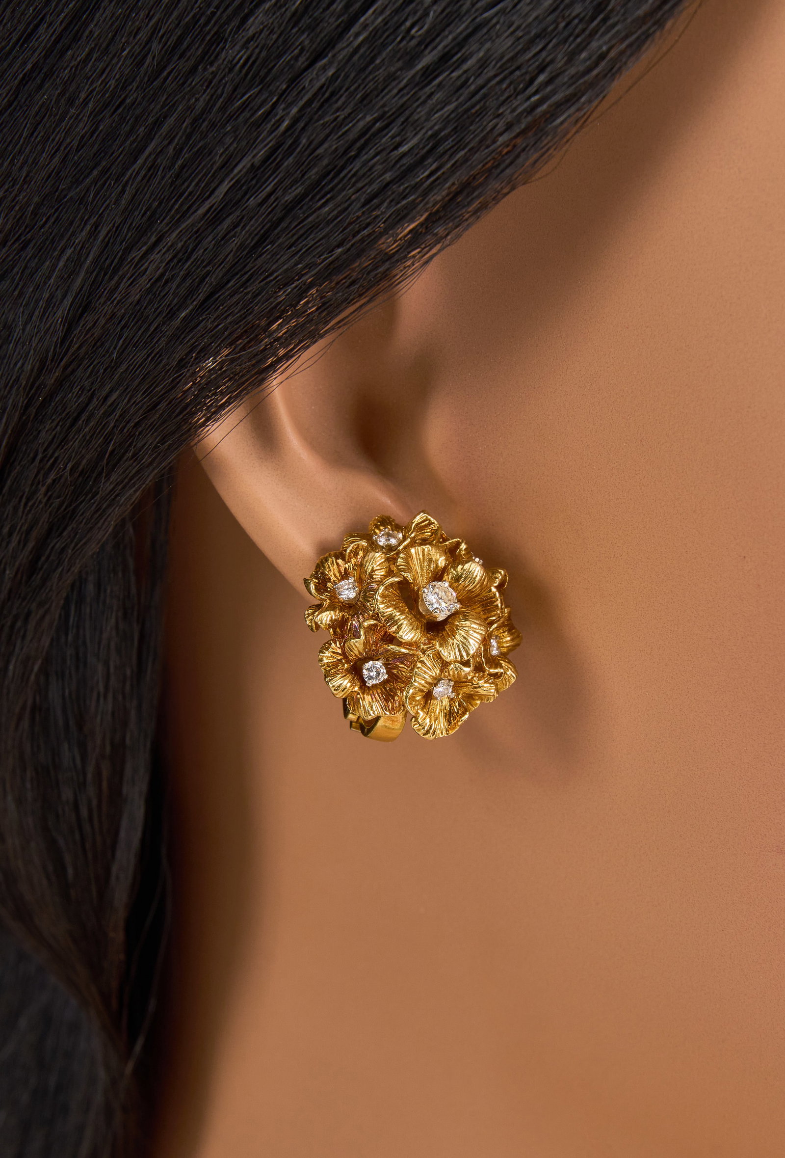 18K Diamond Flower Earrings: Pair of 18K yellow gold clip-on flower earrings, set with round brilliant cut diamonds measuring approximately 0.62 ctw, marked "18K" Total weight: 20.3 g Provenance: Property