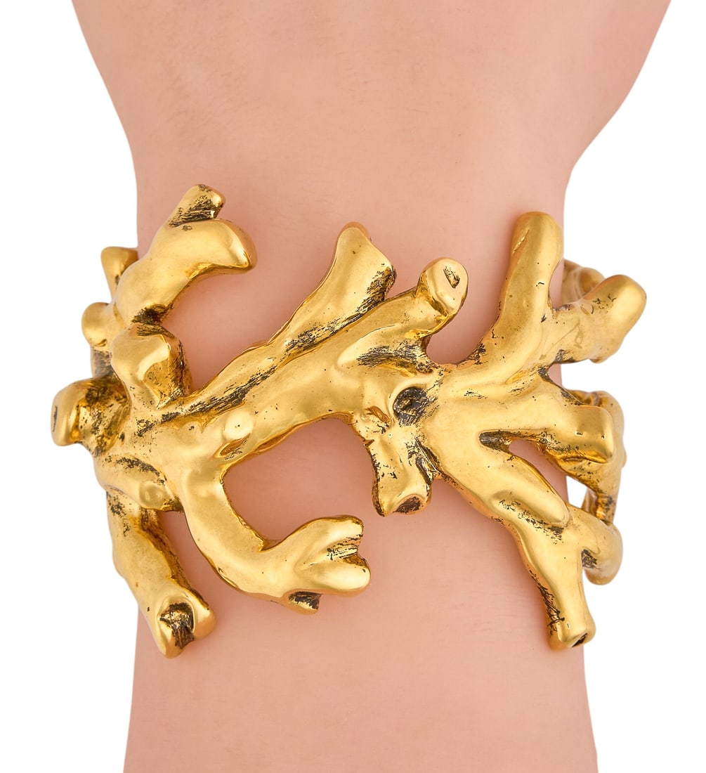 Saint Laurent Brass Coral Cuff: Saint Laurent coral motif brass cuff, includes original dust bag and box Length: 6.25 in. Total weight: 156.3 g Provenance: Property from a home in San Antonio, Texas