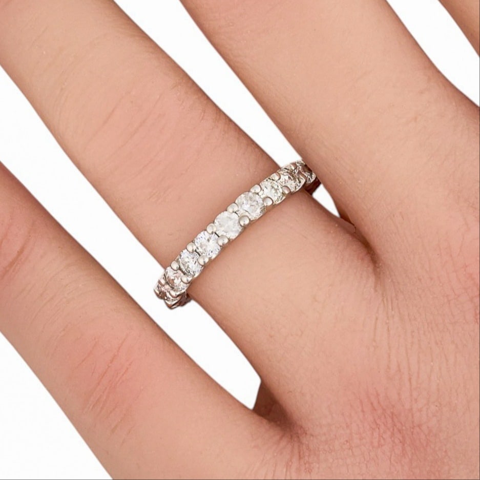 14K Diamond Eternity Ring: 14K white gold ring set with 2.0 ctw round brilliant cut diamonds, VS2-SI2 clarity and E-F color, with GGA appraisal report Size: 6.5 Total weight: 2.5 g Provenance: Property from the collection of