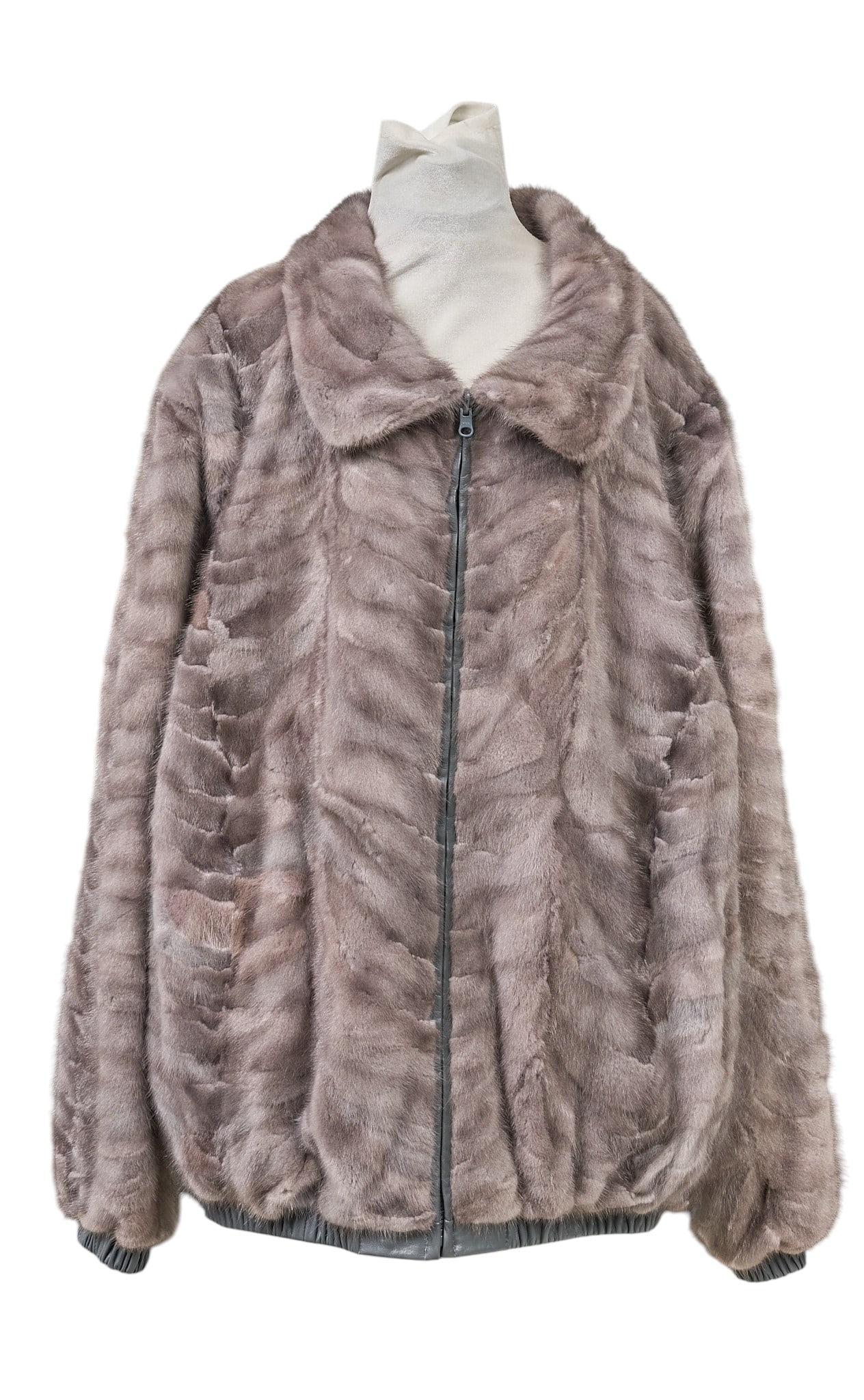 Fox & Leather Jacket: Fox and leather jacket with zipper closure and two slit pockets length from top of collar: 29 in. shoulder width: 20 in. sleeve length: 27 in. Provenance: Property from the Estate of