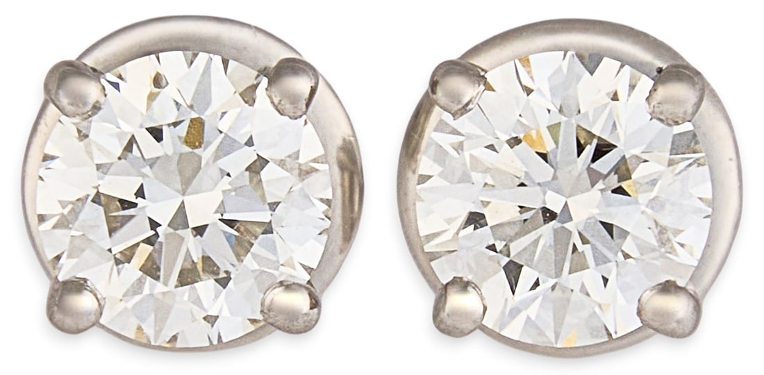 Platinum GIA Diamond Stud Earrings: Platinum stud earrings set with two round brilliant cut diamonds each approximately 0.5 ct, approximately 1.0 ctw, graded J color and VS2 clarity, with GIA reports and laser inscription