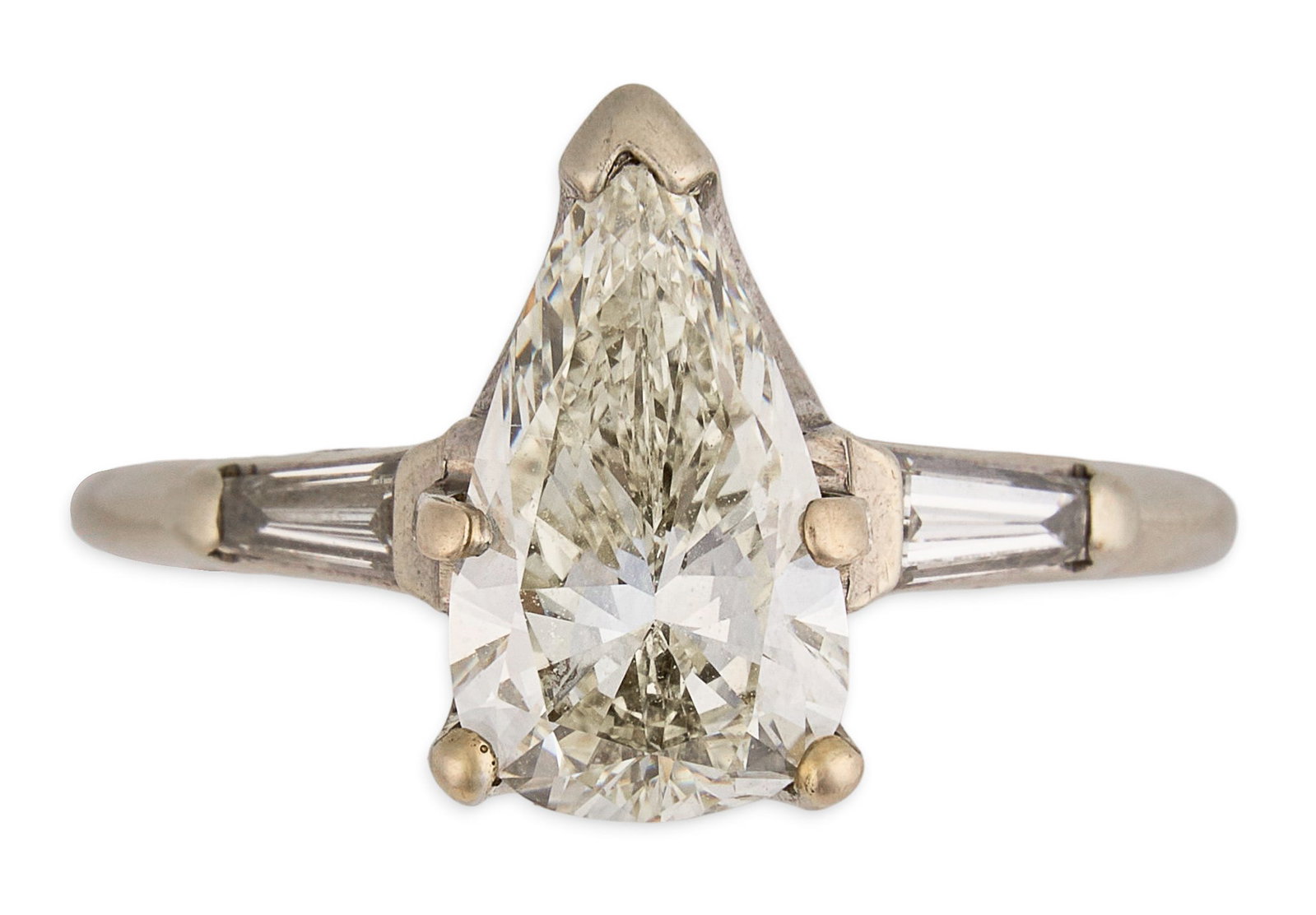 14K Diamond Ring: 14K white gold ring set with pear cut diamond center stone approximately 2.0 ct, flanked by two baguette cut diamonds, approximately 0.4 ctw, marked "14K" Size: 7.25 Total weight: 3.6 g Prov