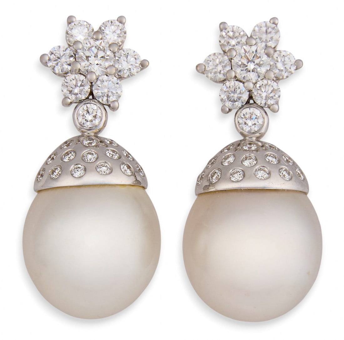 14K Pearl & Diamond Dangle Earrings: Pair of 14K white gold (tested) dangle earrings, set with round cultured pearls, accented by round brilliant cut diamonds Size: 1 1/8 in. / length Total weight: 10.1 g