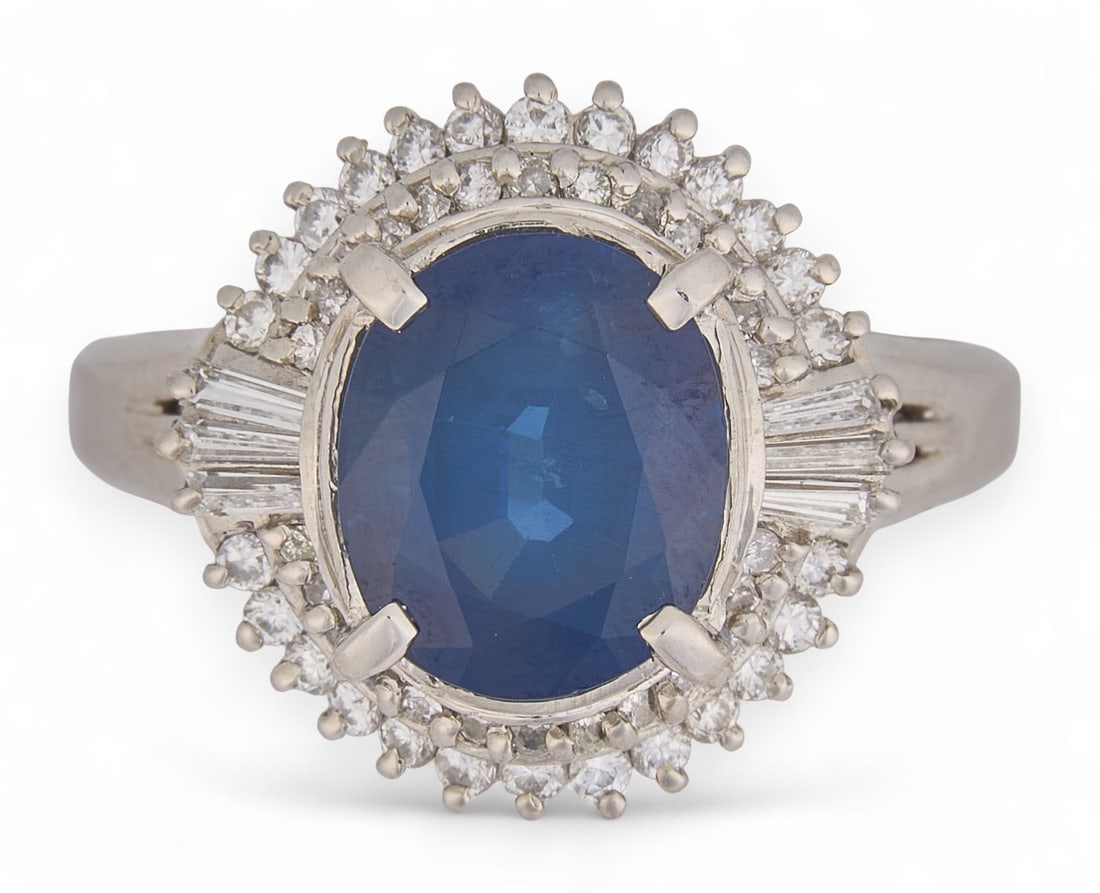 GIA 3.99 CT Sapphire & Diamond Ring: GIA certified sapphire and diamond platinum ring, featuring a 3.99 ct. brilliant oval cut sapphire, accented by round brilliant cut diamonds, marked "PT900" Size: 8.5 Total weight: 9.6